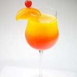 Tequila Sunrise garnished with orange and cherry, shot on a white background.
