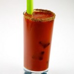 Bloody Mary Coctail with celery stalk and pitcher.